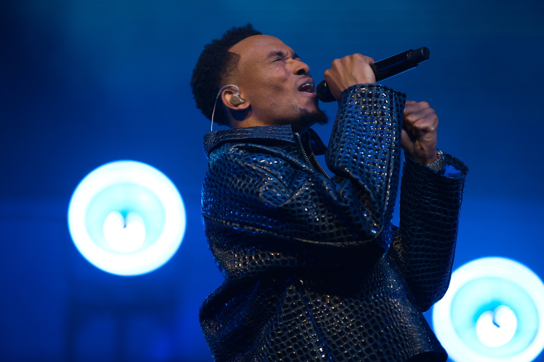 Singer performing in blue stage light